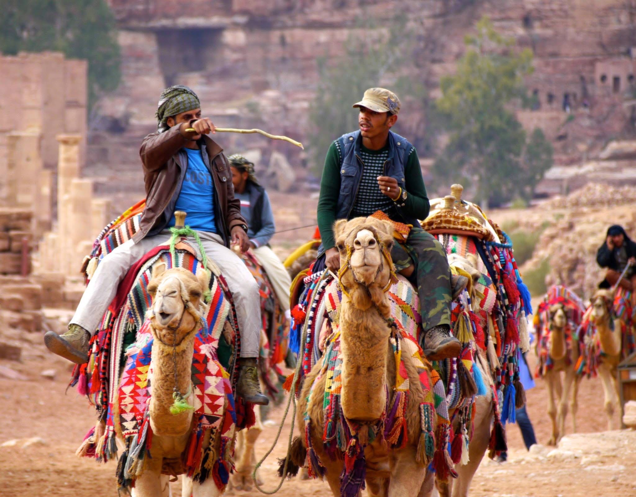 Two riders coming up the colonnaded street